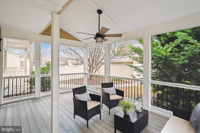 sunroom / solarium featuring ceiling fan and lofted ceiling