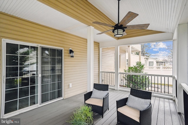 deck featuring covered porch and ceiling fan