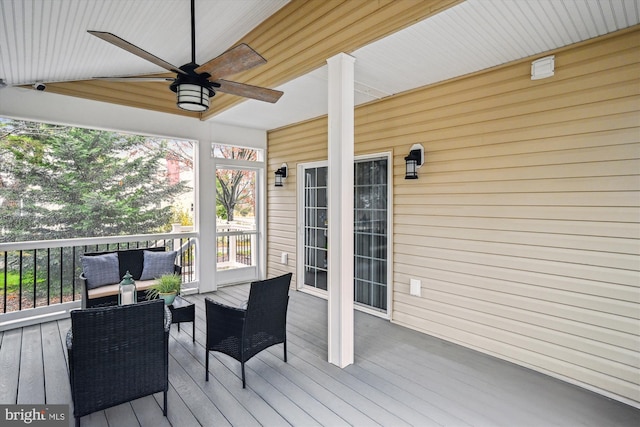 deck with outdoor lounge area and ceiling fan