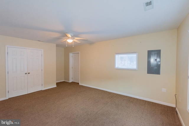 unfurnished bedroom featuring electric panel, carpet floors, and ceiling fan