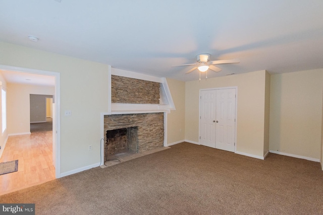 unfurnished living room featuring a fireplace, ceiling fan, and carpet