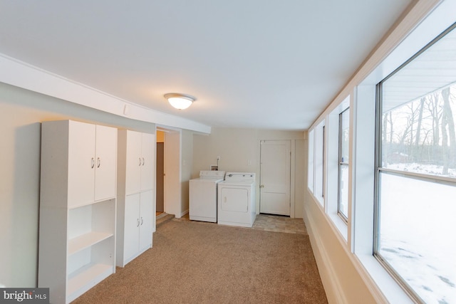 washroom with separate washer and dryer and light carpet