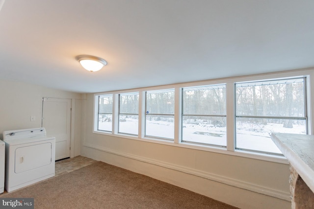 clothes washing area featuring washer / clothes dryer, carpet, and plenty of natural light