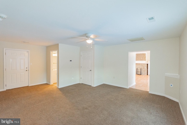 unfurnished room featuring ceiling fan and light colored carpet