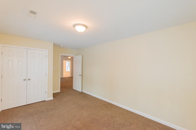 unfurnished bedroom featuring a closet and carpet