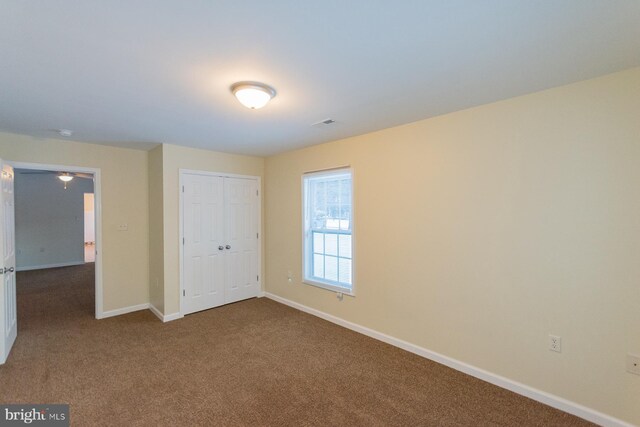 unfurnished bedroom featuring a closet and carpet