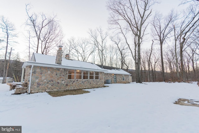 view of snow covered back of property