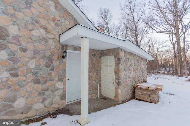 view of snow covered property entrance