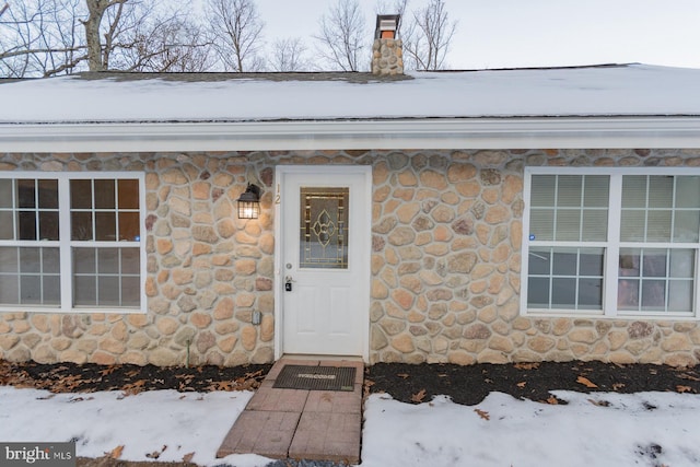 view of snow covered property entrance