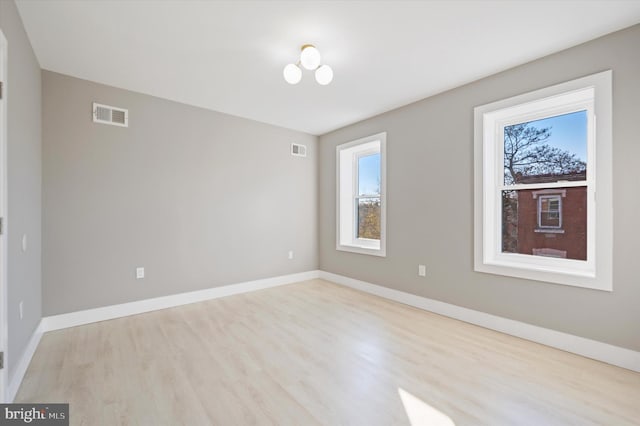 spare room featuring light wood-type flooring