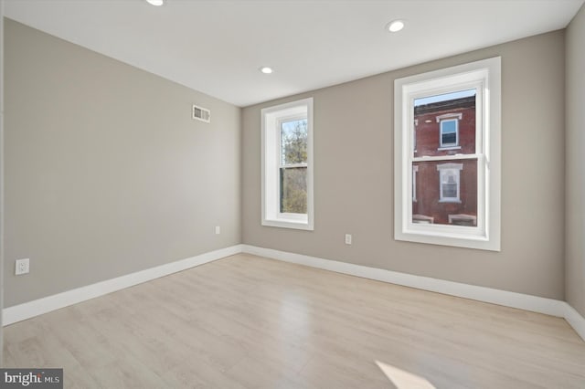 empty room with light hardwood / wood-style flooring