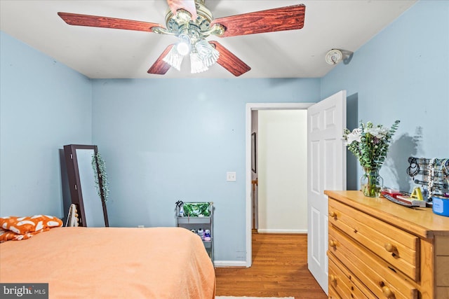 bedroom with hardwood / wood-style floors and ceiling fan