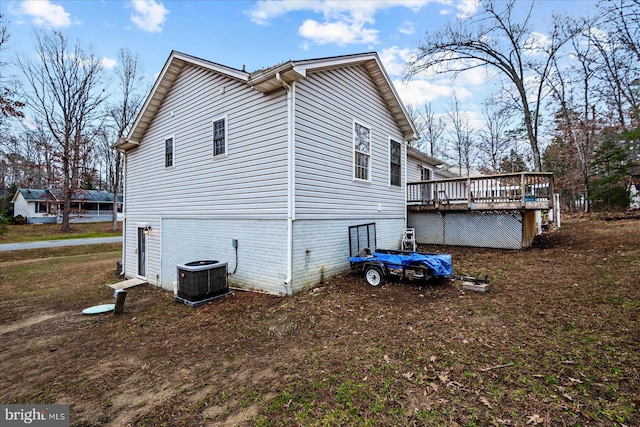 view of side of property featuring a deck and central air condition unit