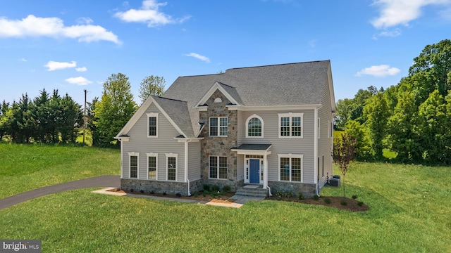 view of front of home featuring a front lawn and central AC unit