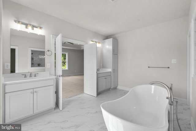 bathroom with vanity and a tub