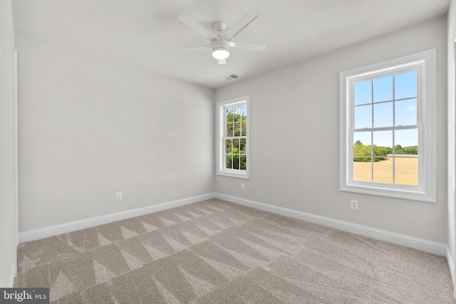 carpeted empty room featuring ceiling fan