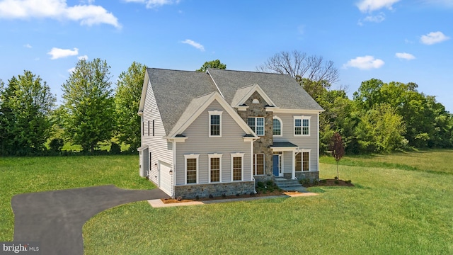 view of front of house featuring a front yard and a garage