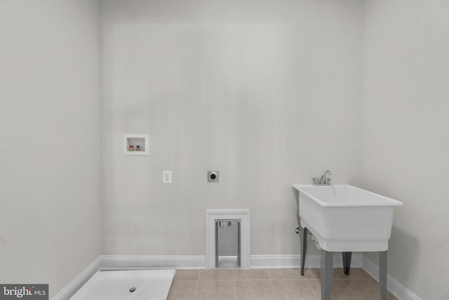 laundry area with washer hookup, electric dryer hookup, and light tile patterned flooring