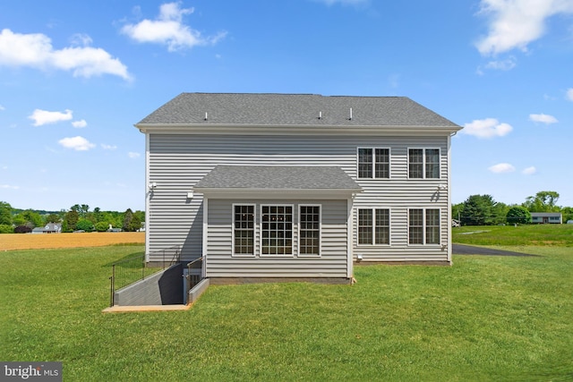 back of house with a lawn