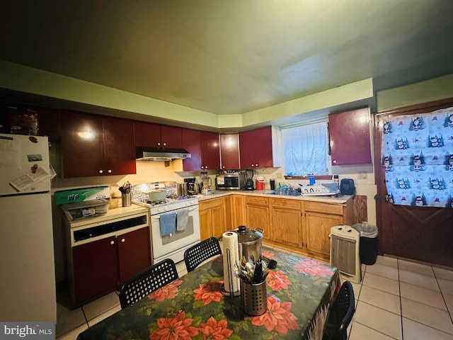 kitchen with light tile patterned flooring, white appliances, and sink