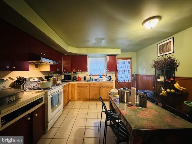 kitchen featuring white range with gas cooktop and light tile patterned floors