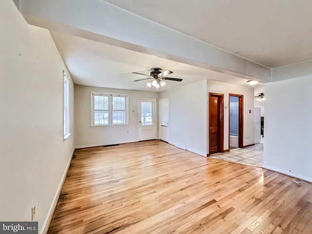 spare room featuring ceiling fan and light hardwood / wood-style flooring