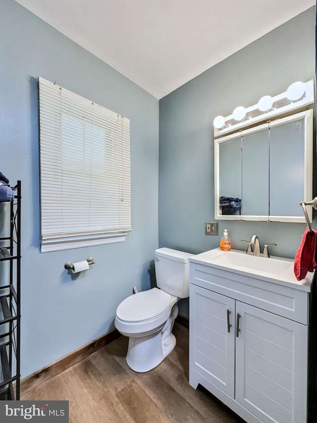 bathroom with vanity, hardwood / wood-style flooring, and toilet