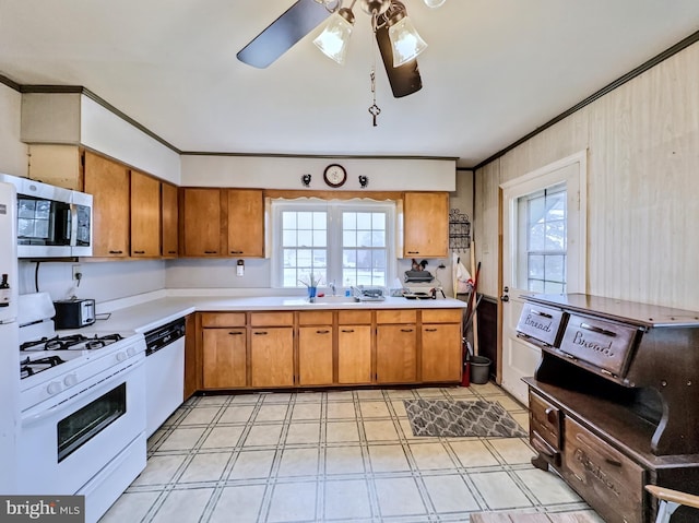 kitchen featuring white appliances, a wealth of natural light, ornamental molding, and ceiling fan