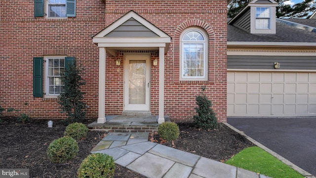 view of exterior entry featuring a garage