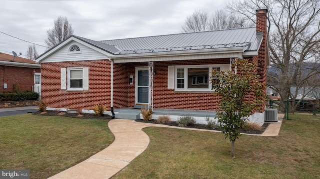 view of front of property featuring a front yard and central AC