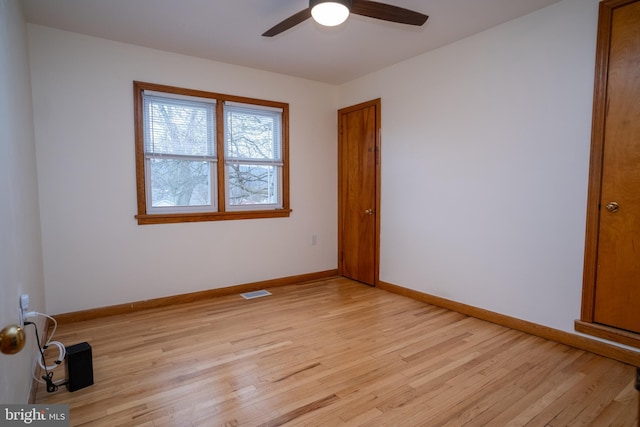 spare room featuring ceiling fan and light wood-type flooring