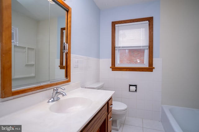 bathroom featuring a tub, tile patterned flooring, toilet, vanity, and tile walls