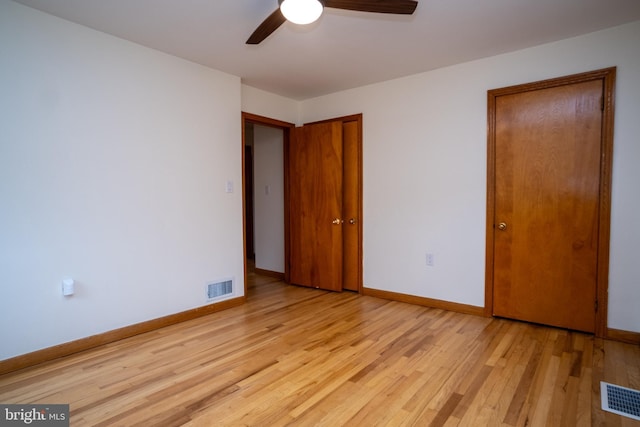 unfurnished bedroom with ceiling fan and light wood-type flooring