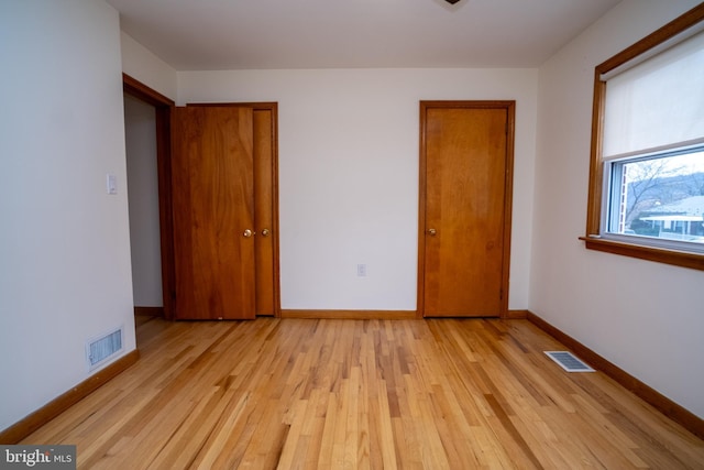 unfurnished bedroom with light wood-type flooring