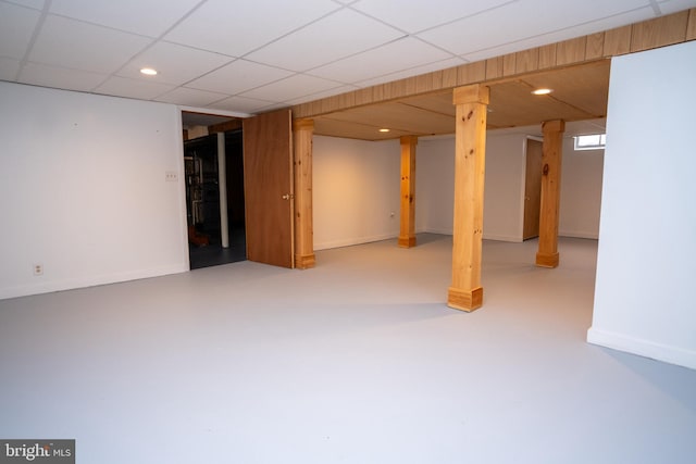 basement with a paneled ceiling