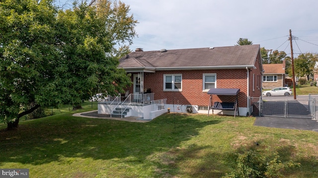 back of property featuring a lawn