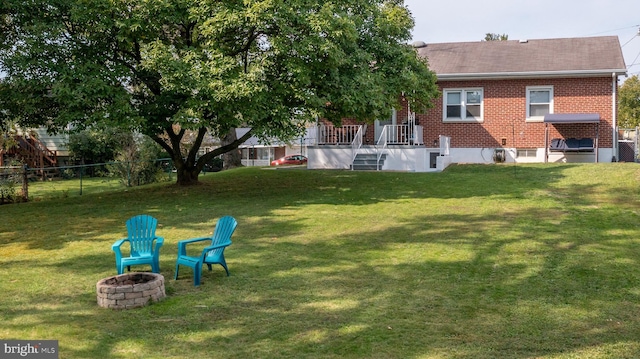 view of yard featuring an outdoor fire pit