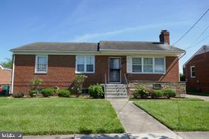 2215 Iverson St, Temple Hills, MD 20748 - view of front of property featuring a front lawn, a chimney, and brick siding