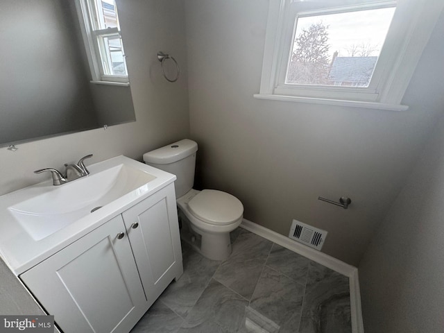 bathroom featuring vanity and toilet