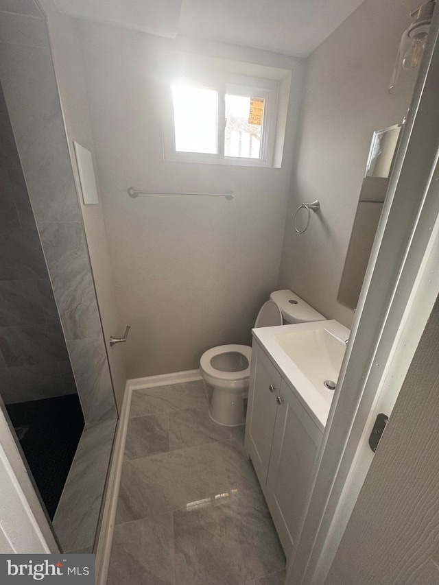 bathroom featuring tile patterned floors, a shower, vanity, and toilet