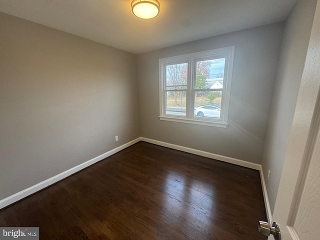 spare room with dark wood-type flooring