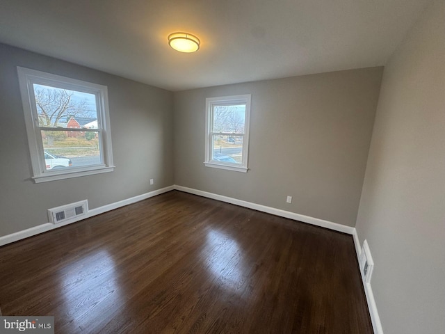 unfurnished room featuring dark hardwood / wood-style floors