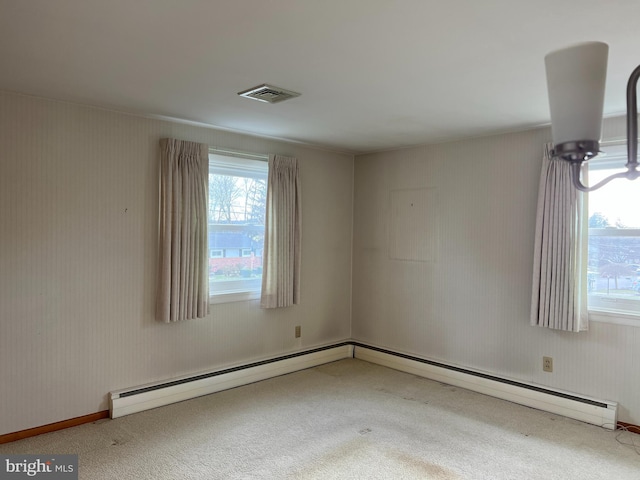 spare room with carpet, a healthy amount of sunlight, and a baseboard radiator