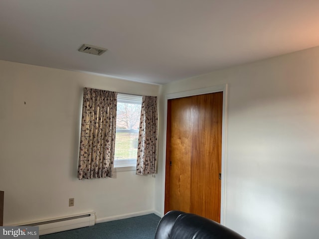 sitting room featuring carpet flooring and baseboard heating