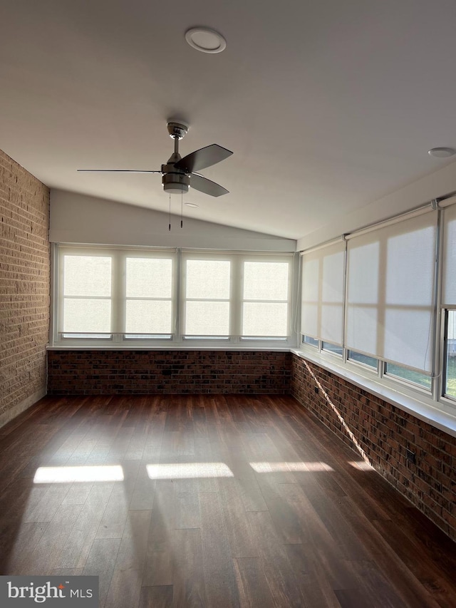 unfurnished sunroom featuring ceiling fan, a wealth of natural light, and vaulted ceiling