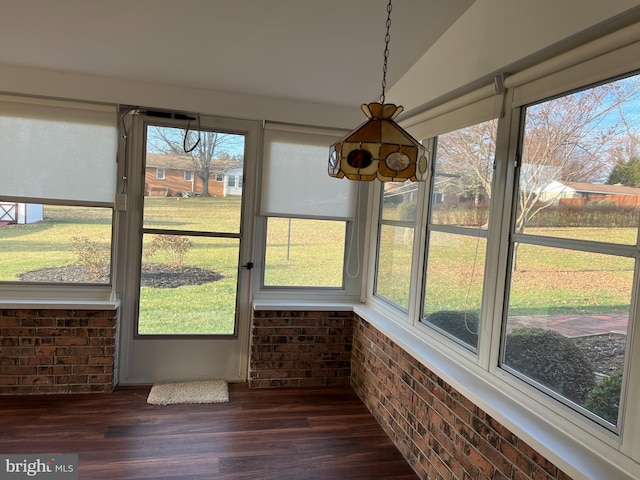 unfurnished sunroom with a healthy amount of sunlight and lofted ceiling