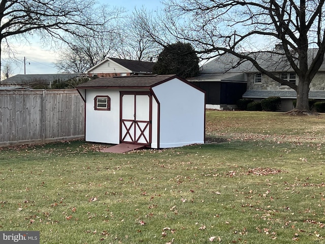 view of outbuilding with a yard