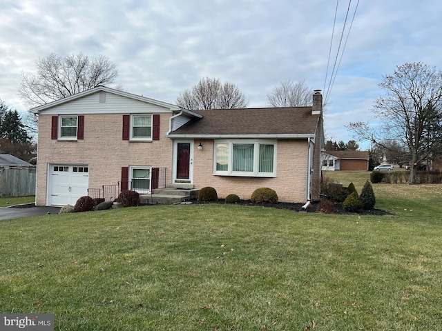 tri-level home with a front yard and a garage