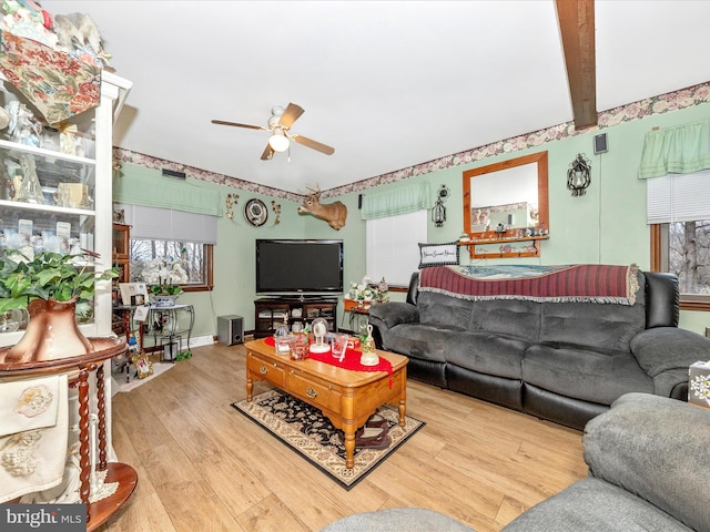 living room with beamed ceiling, ceiling fan, and light hardwood / wood-style flooring