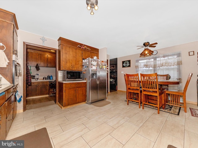 kitchen with appliances with stainless steel finishes and ceiling fan